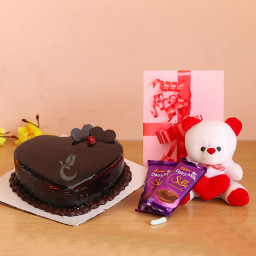 Nourishing Incarnation: A Gift Combo of 0.5 Kg Heart Shape Chocolate Cake, 2 Dairy Milk Silk Chocolates, 6 Inch Teddy, and 1 Greeting Card