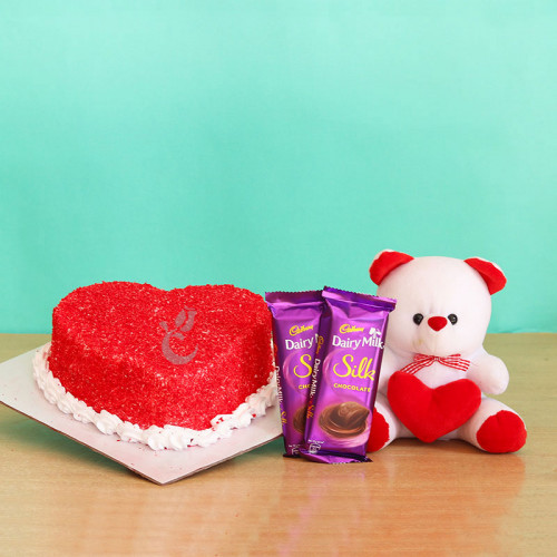 Infused With Love: A Gift Combo of 0.5 Kg Red Velvet Cake, 2 Dairy Milk Silk, and 6 Inch Teddy