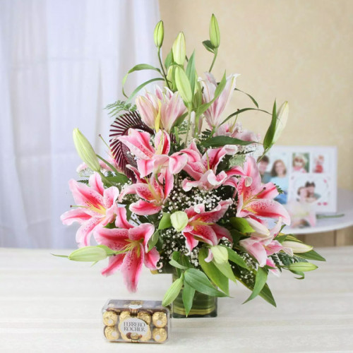 Friendly Surprise: A Gift Combo of 10 Pink Lily with Vase Arrangement and 16 Ferrero Rocher