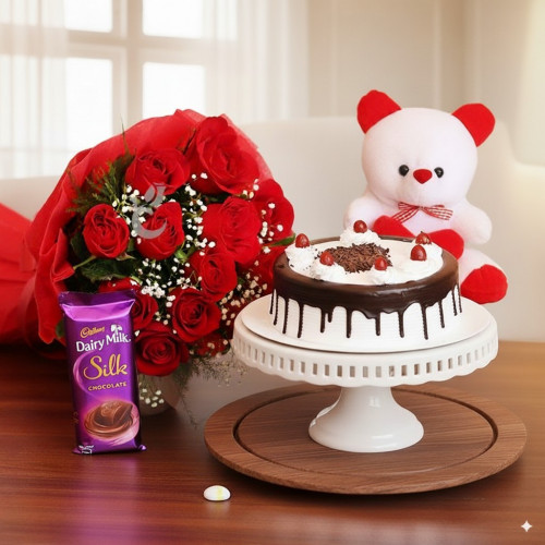 Pampering Surprise: A Gift Combo of 10 red roses, 2 Cadbury Dairy Milk Silk, 0.5 Kg Black Forest cake and 6 inch teddy bear