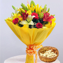 Glaze Of Happiness: A Gift Combo of 5 Yellow Lily, 5 Red Rose, 5 Yellow Rose, 2 Red Lily and 500 gm Mix Dry Fruit in Basket