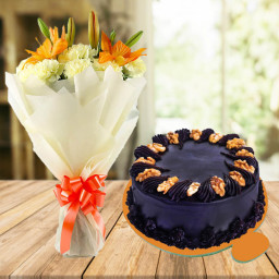 Softness Scripted: A Gift Combo of 10 Yellow Carnations, 2 Yellow Lilies and 0.5 kg Choco Walnut Cake