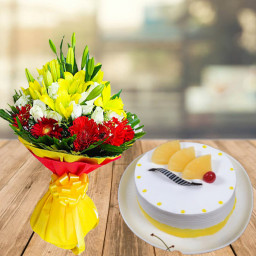 Let Love Stay With You: A Gift Combo of 6 Yellow Lilies, 12 White Roses, 10 Red Gerberas and 0.5 kg Pineapple Cream Cake