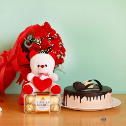 Romantic Zeal: A Gift Combo of 10 red roses bouquet, 6-inch soft toy, Ferrero Rocher and 0.5 kg chocolate cake