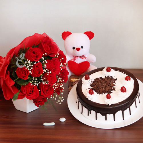 Bountiful Wishes: A Gift Combo of 12 red roses, 6 inch teddy and 0.5 kg Black Forest cake
