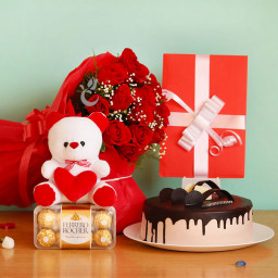 Striking Emotions: A Gift Combo of 12 red roses, 16 pcs Ferrero Rocher, 0.5 kg chocolate cake, greeting card and 6 inch teddy