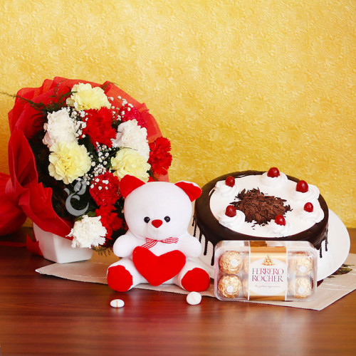 Celebration of Love: A Gift Combo of 0.5 Kg Black Forest Cake, 10 Mix Carnations, 6 Inch Teddy and 16 Ferrero Rocher