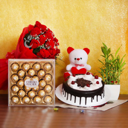 Red Rush: A Gift Combo of 12 Red Roses, 0.5 Kg Black Forest Cake, Lucky Bamboo, 24 Ferrero Rocher and 6 Inch Teddy