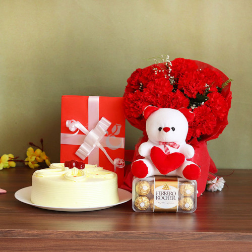 Love Extravaganza: A Gift Combo of 12 Carnation, 6 Inch Teddy, One Greeting Card, 16 Ferrero Rocher, 0.5 Kg Butterscotch
