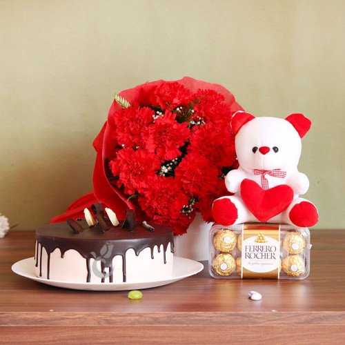 Dreamy Affair: A Gift Combo of 12 Carnation, 6 Inch Teddy, 16 Ferrero Rocher, and 0.5 Kg Chocolate Cake